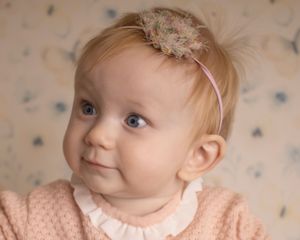 A baby girl looks to the side