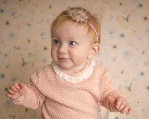 A baby girl looks just off camera