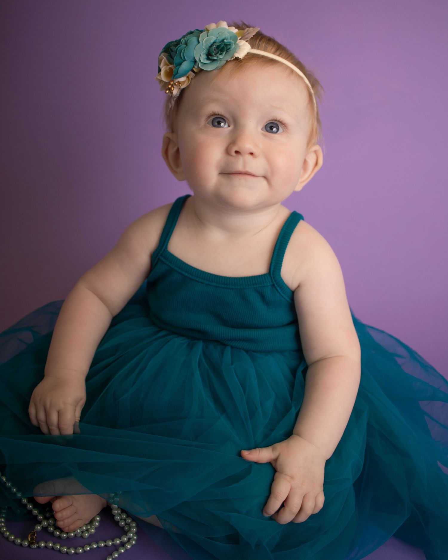 A baby girl looks up high