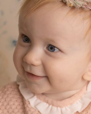 A close up of a baby girl looking to the side