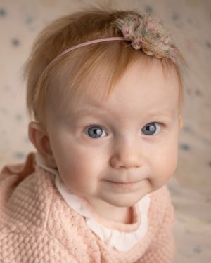 A baby girl stares into the camera