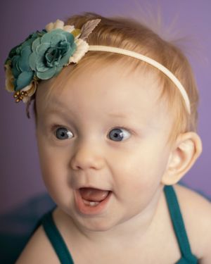 A baby girl with a surprised expression
