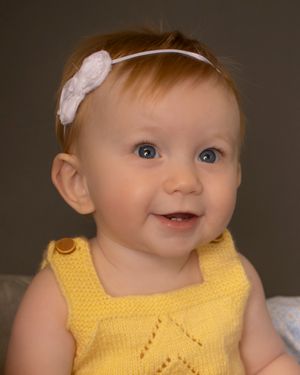 A baby girl smiles brightly