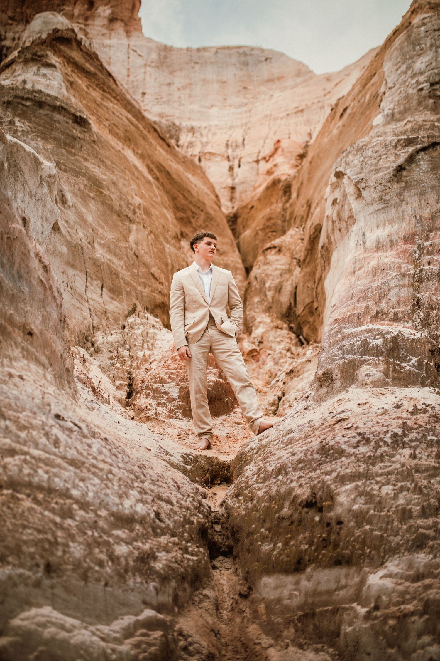 Stunning rock formations in a desert canyon with warm sunlight filtering through the narrow sandstone walls.