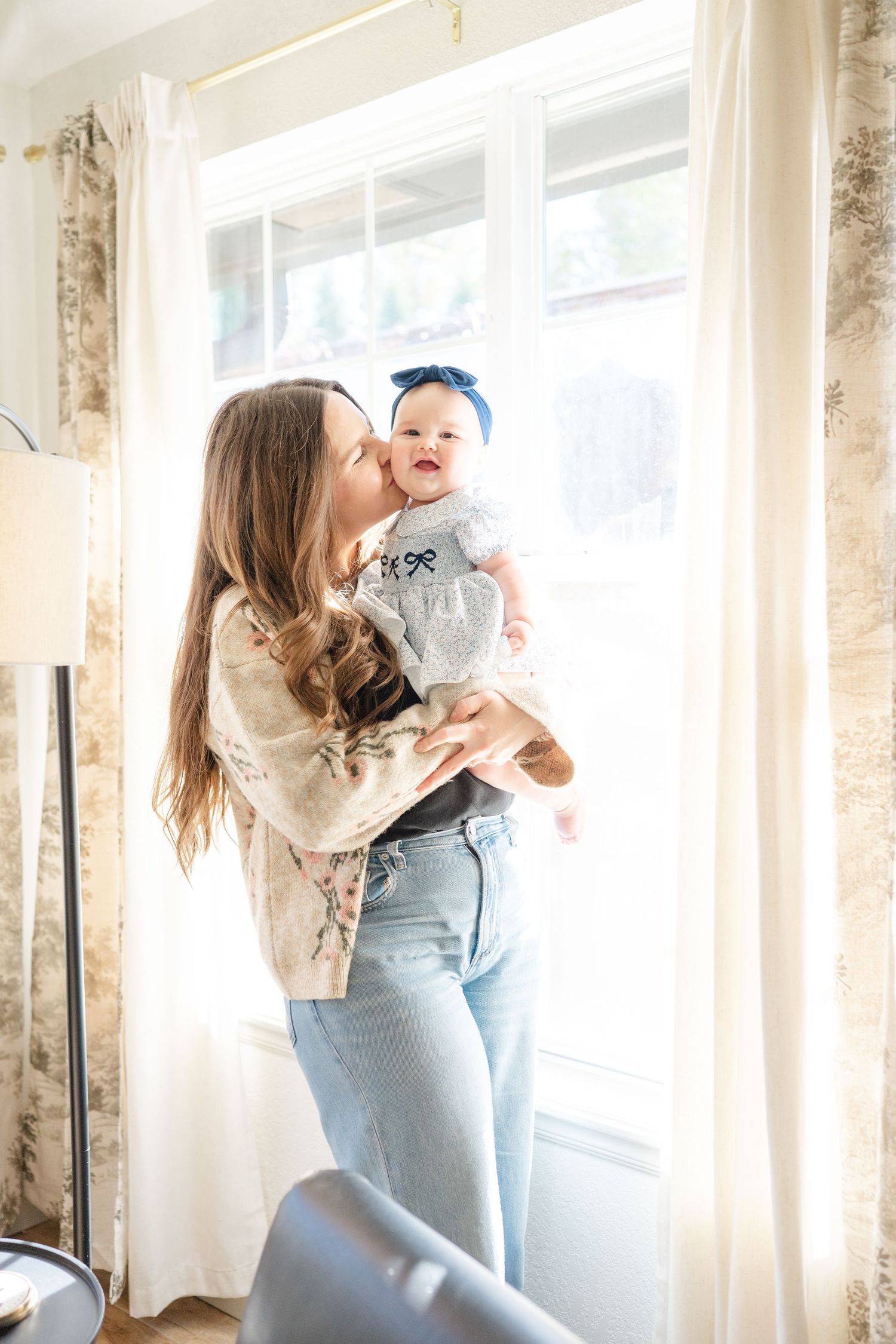 siblings holding newborn in lap for lifestyle family photography