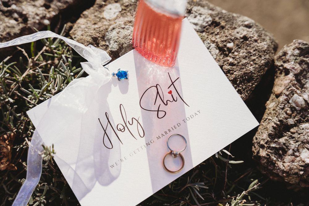 Handwritten wedding notes and details laid out on rustic stone surface.