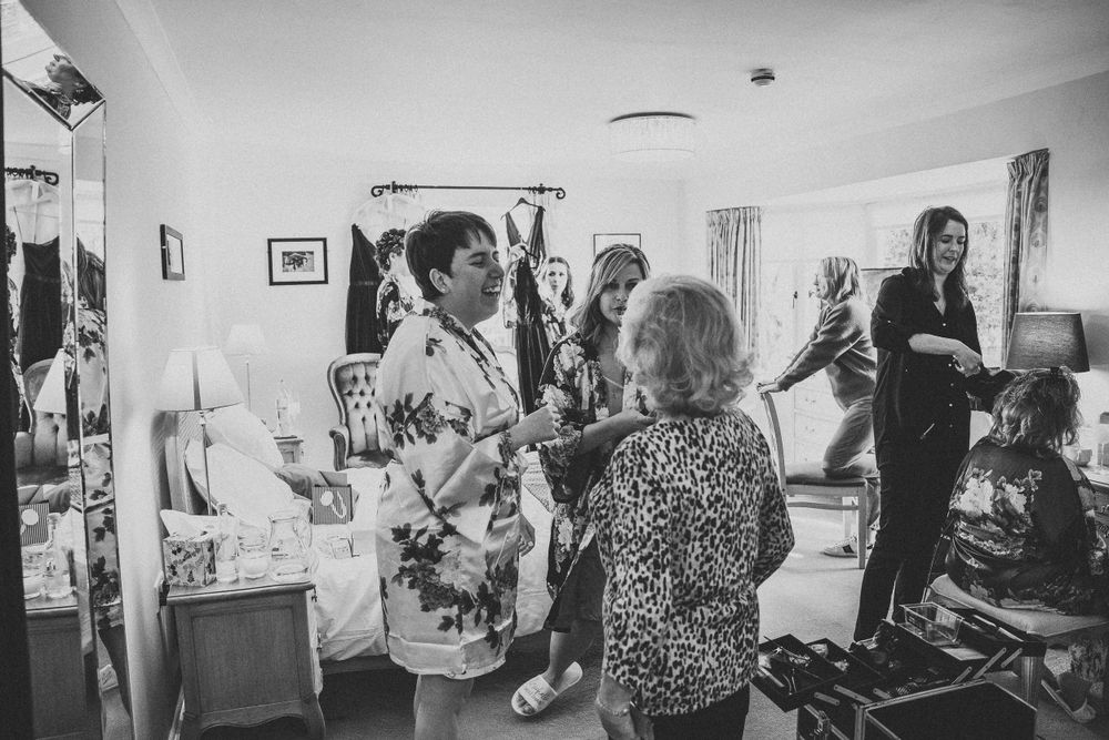 Wedding guests mingle and celebrate during a joyful indoor reception.