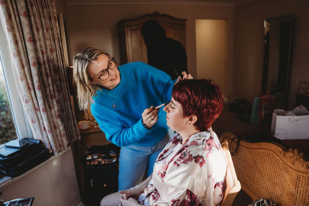 Wedding preparation scene in warm indoor lighting with blue accents.