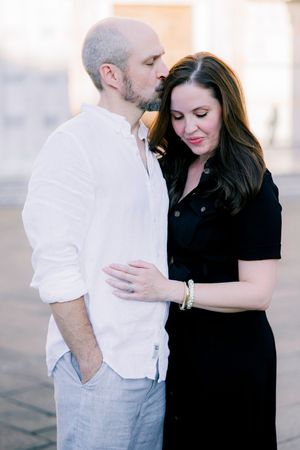 Expectant couple standing close together during a maternity session in Italy.