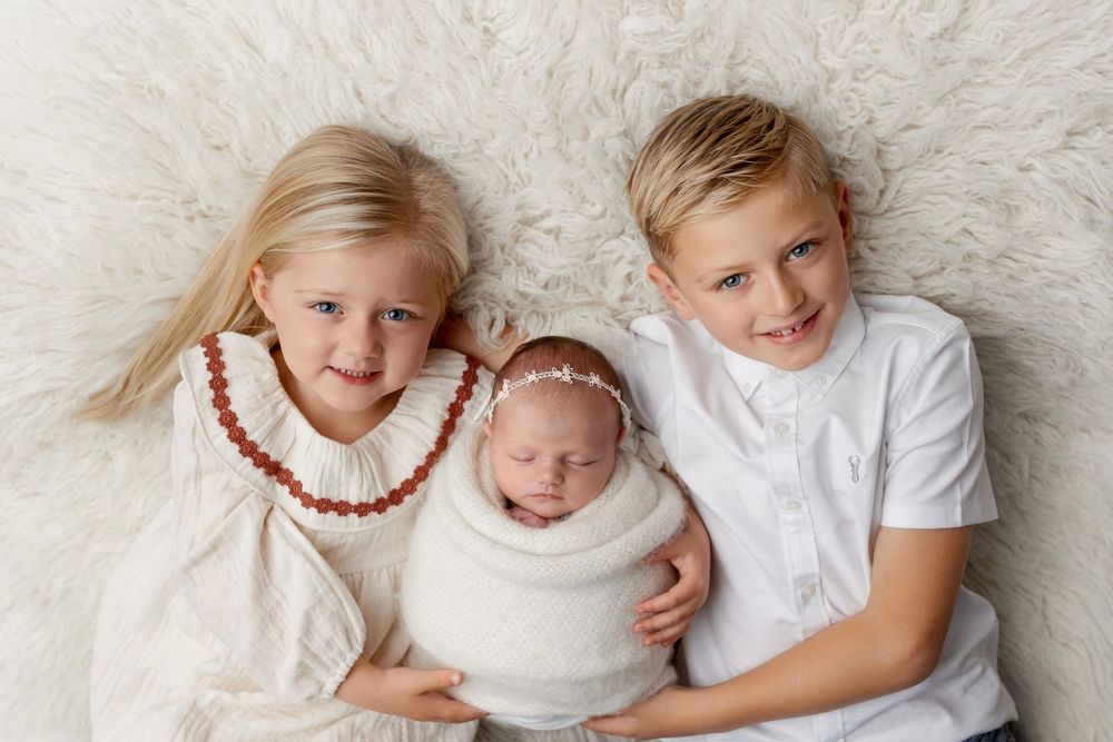 Four heartwarming family photos showing siblings in white outfits posing together on a light-colored background.