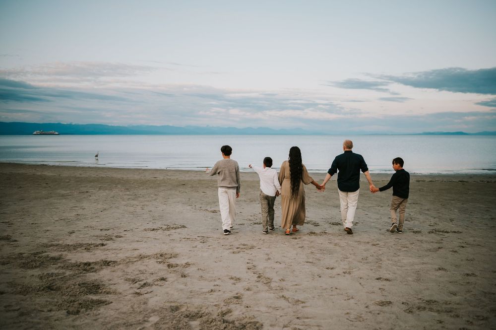 Family photo holding hands and walking on Saratoga beach Campbell River Vancouver Island Photography by Photographer Soulfull Photographs