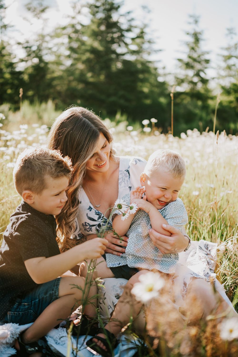 Family of mom, kids and baby laughing in daisy field Comox Valley Vancouver Island Photography by Photographer Soulfull Photographs