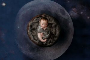 Creative newborn photography series with celestial moon theme against dark starry background.