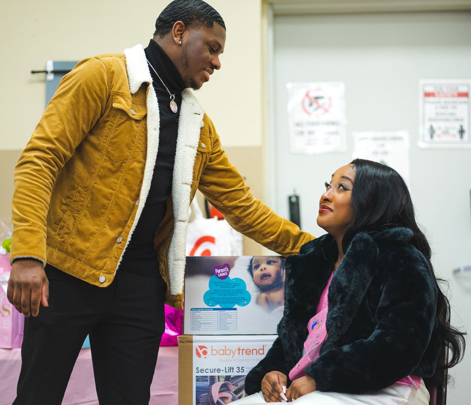 Two people interacting at an indoor event space.