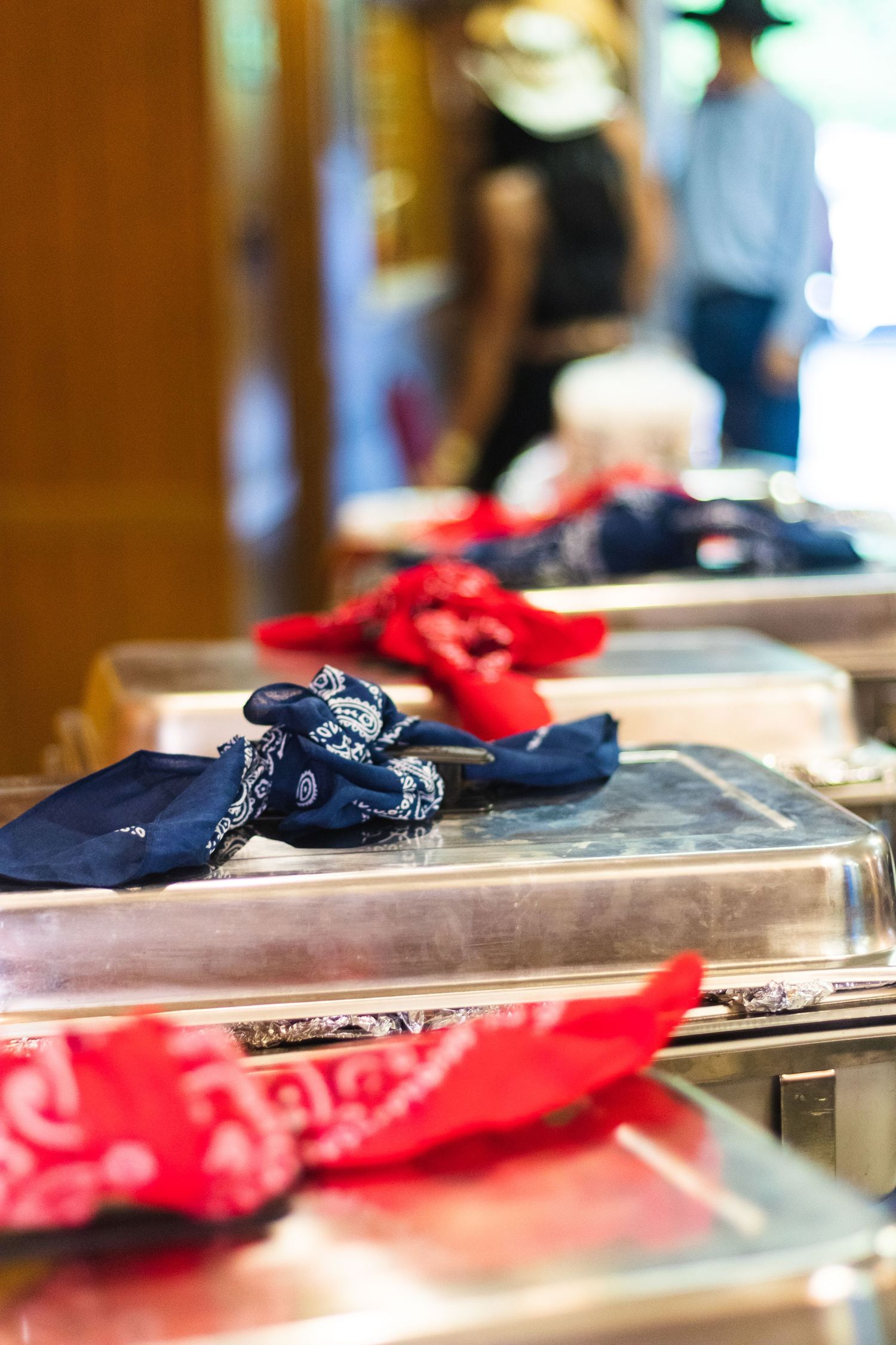 Red and blue bandanas displayed on serving trays at a western-themed event.