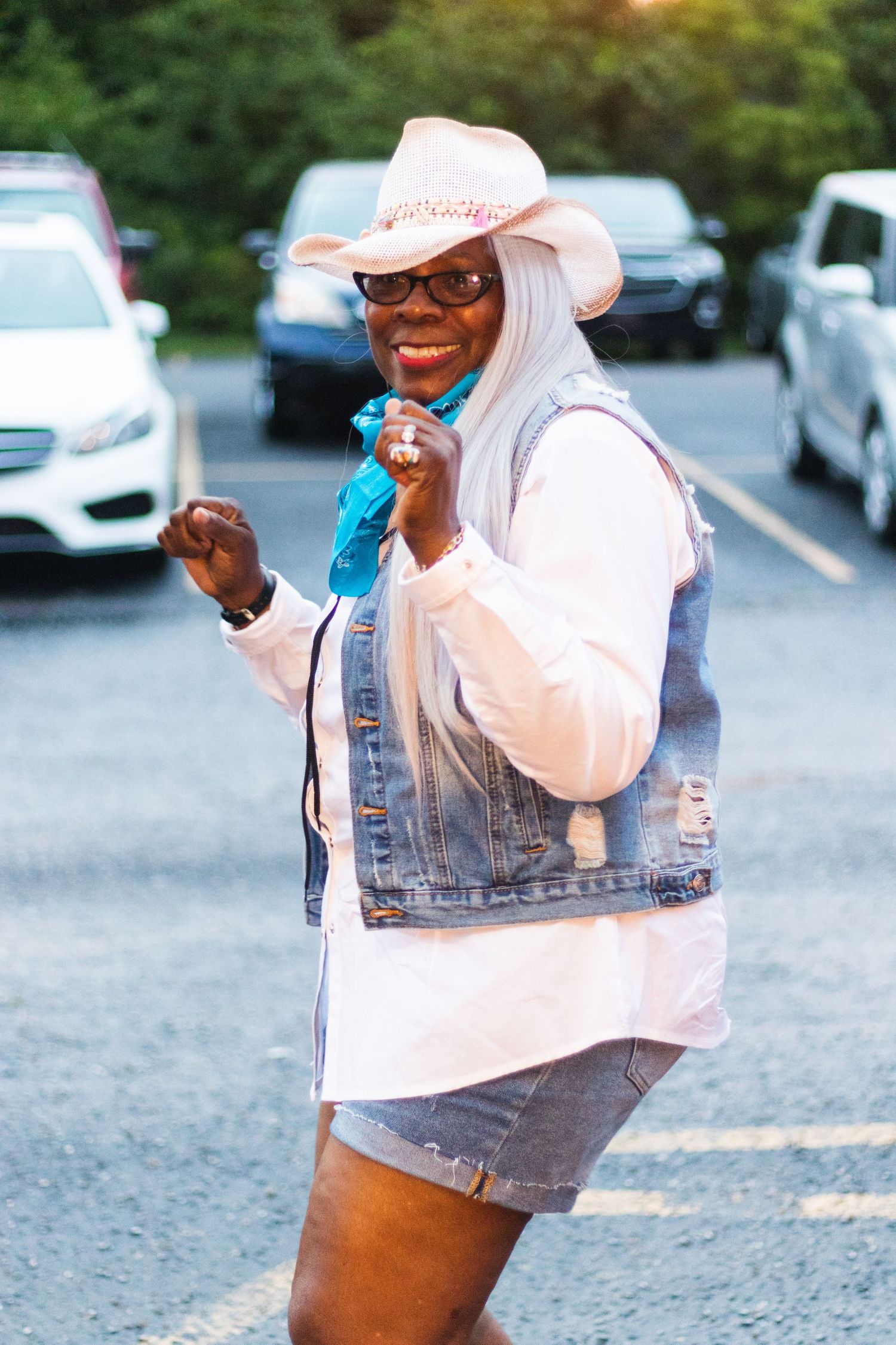 A casual outdoor scene with someone wearing a cowboy hat and denim jacket.