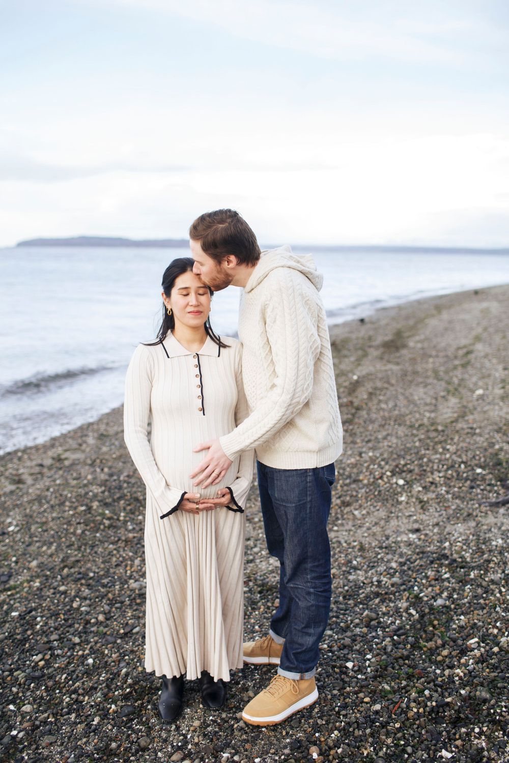 Everett Maternity Photographer: A couple embrace during their maternity photo session at Mukilteo WA