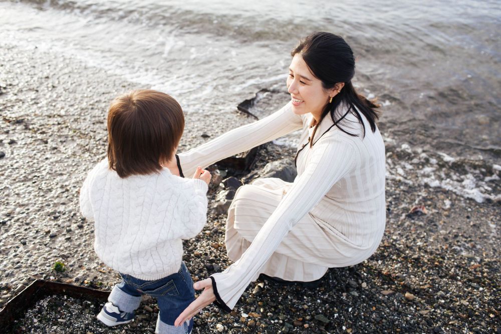 Mukilteo maternity photographer: A beach maternity photo session with a mother and her toddler son in Mukilteo WA