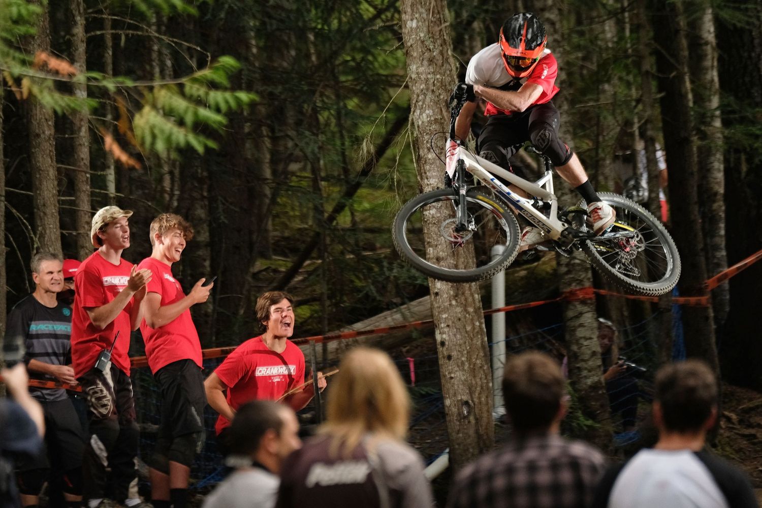 Mountain biker performs aerial stunt in forest setting with crowd watching below.
Whistler Mountain Bike Park
Crankworx