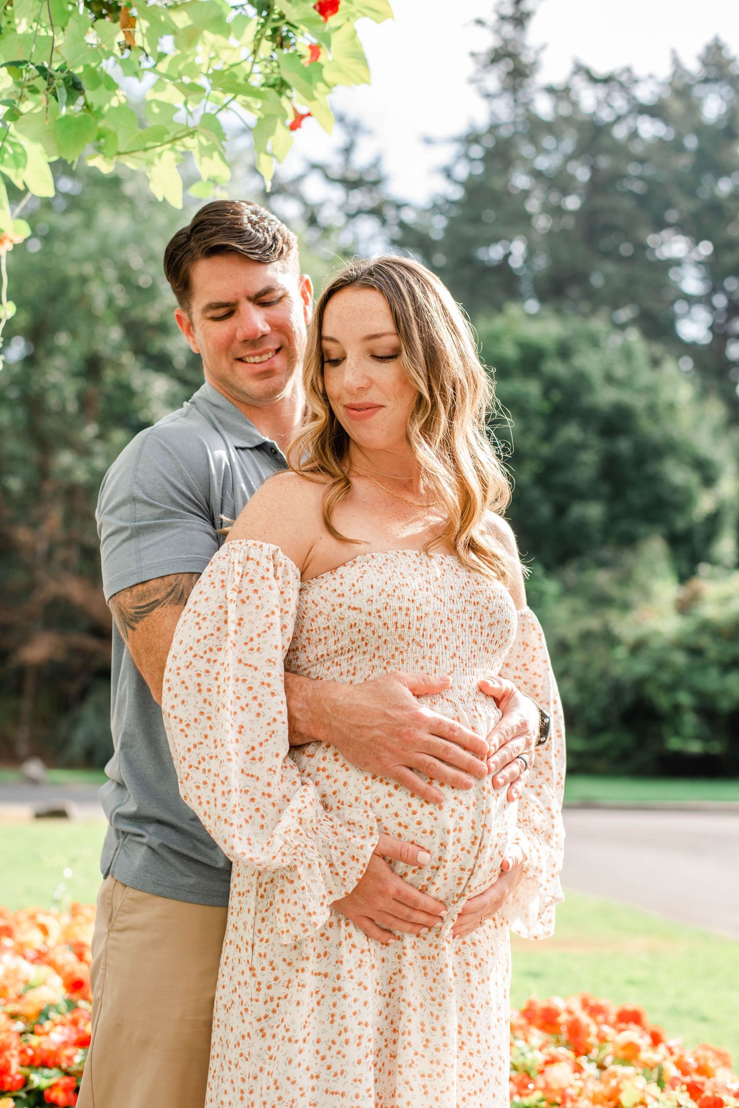 Intimate embrace captured in a garden setting with bright orange flowers and green foliage.