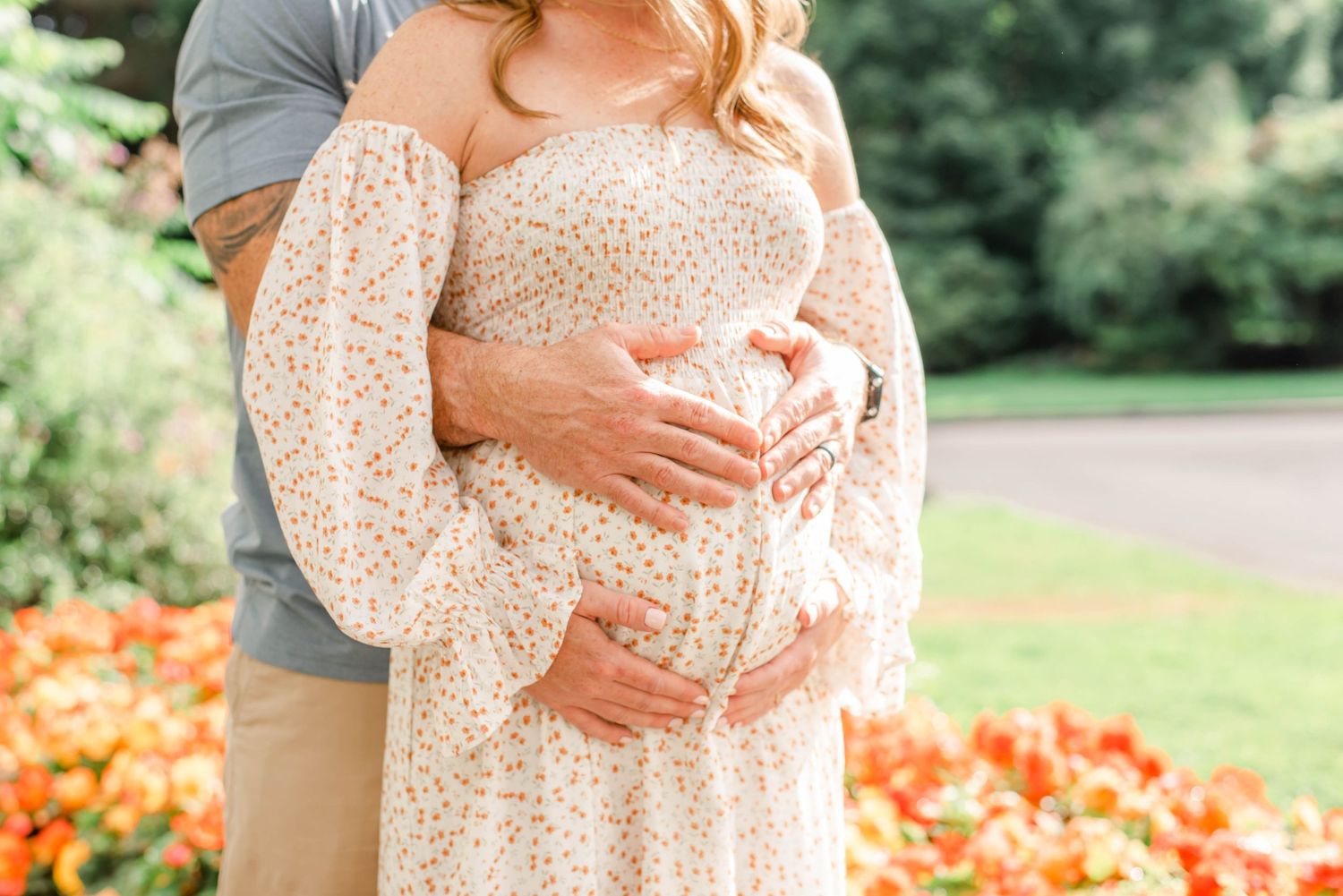 Close-up shot showing embrace against orange flower garden backdrop.