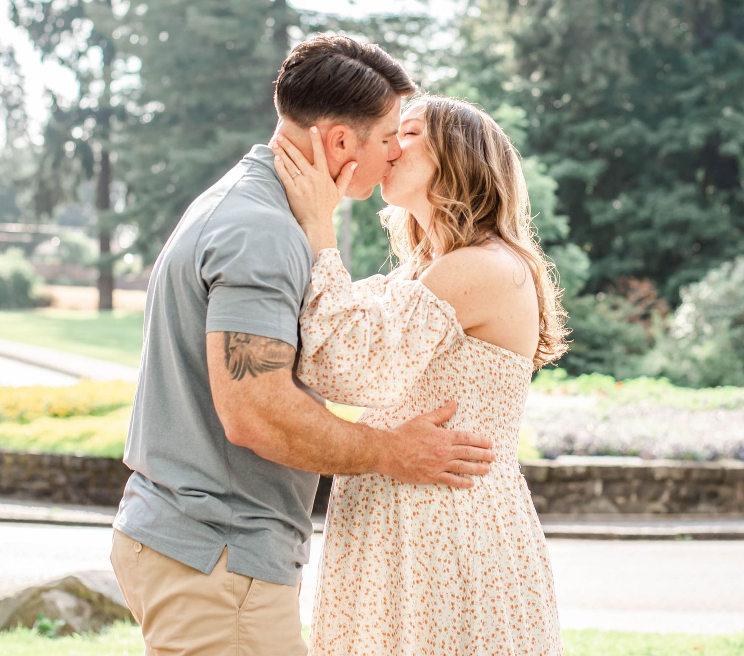 Sweet embrace captured in garden setting with orange flowers and natural greenery.