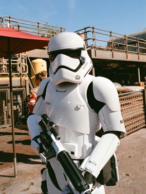 Star Wars Stormtroopers in white armor stand in formation with blaster rifles against a desert backdrop.