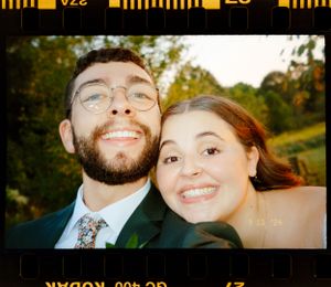 A joyful close up selfie against a lush green natural background.