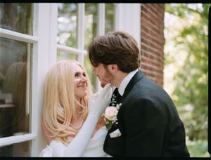 A romantic wedding portrait of newlyweds sharing an intimate moment.