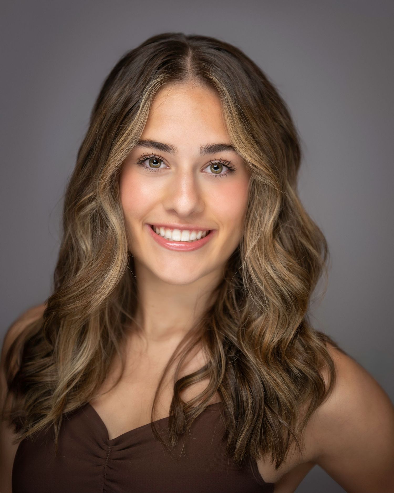 Professional headshot with soft waves and warm lighting against dark background.
Pittsburgh Dance Photographer