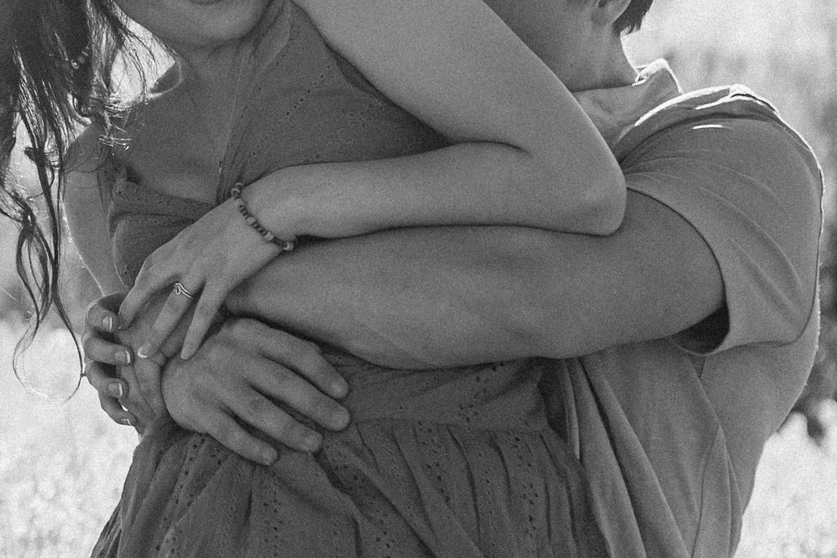 Black and white cropped photo showing gentle embraces and affection.