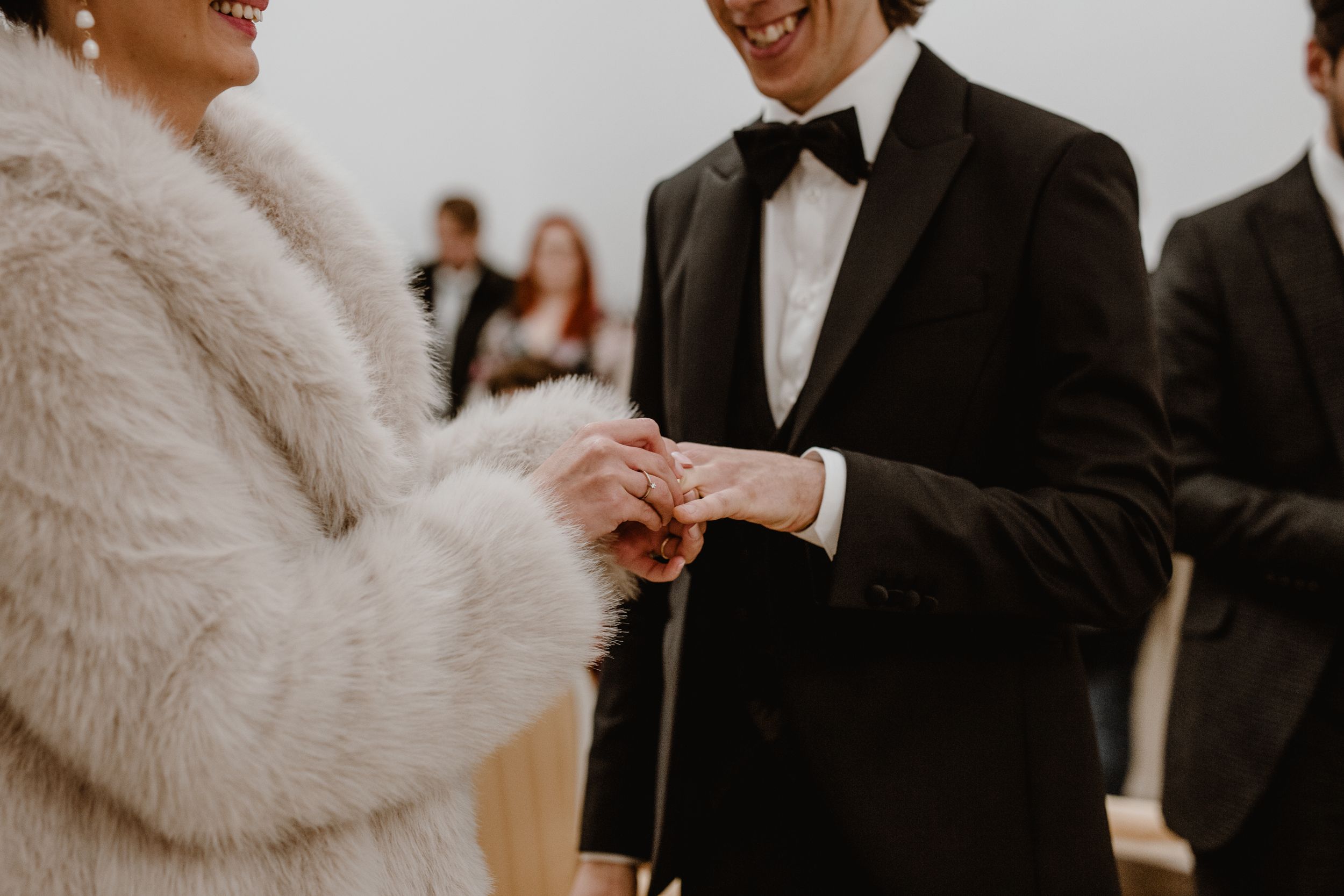Close-up of the bride placing a wedding ring on the groom's finger during a heartfelt ceremony at the Upper Town.
