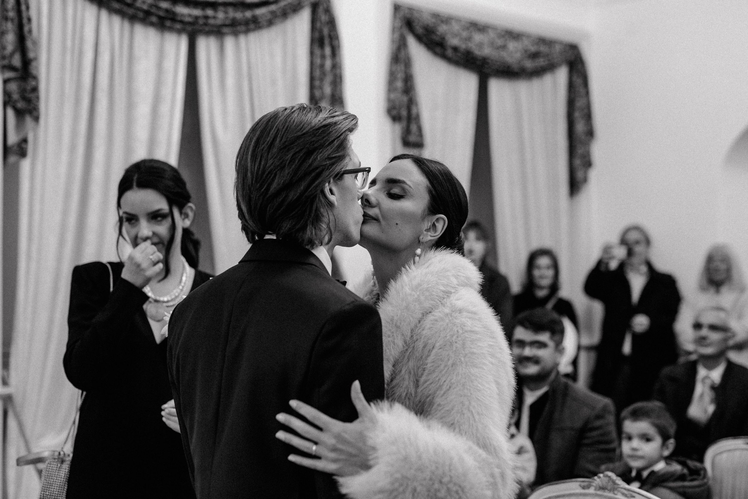 Bride and groom share a joyful kiss after exchanging rings at the Registrar's Office in Upper Town, Zagreb.
