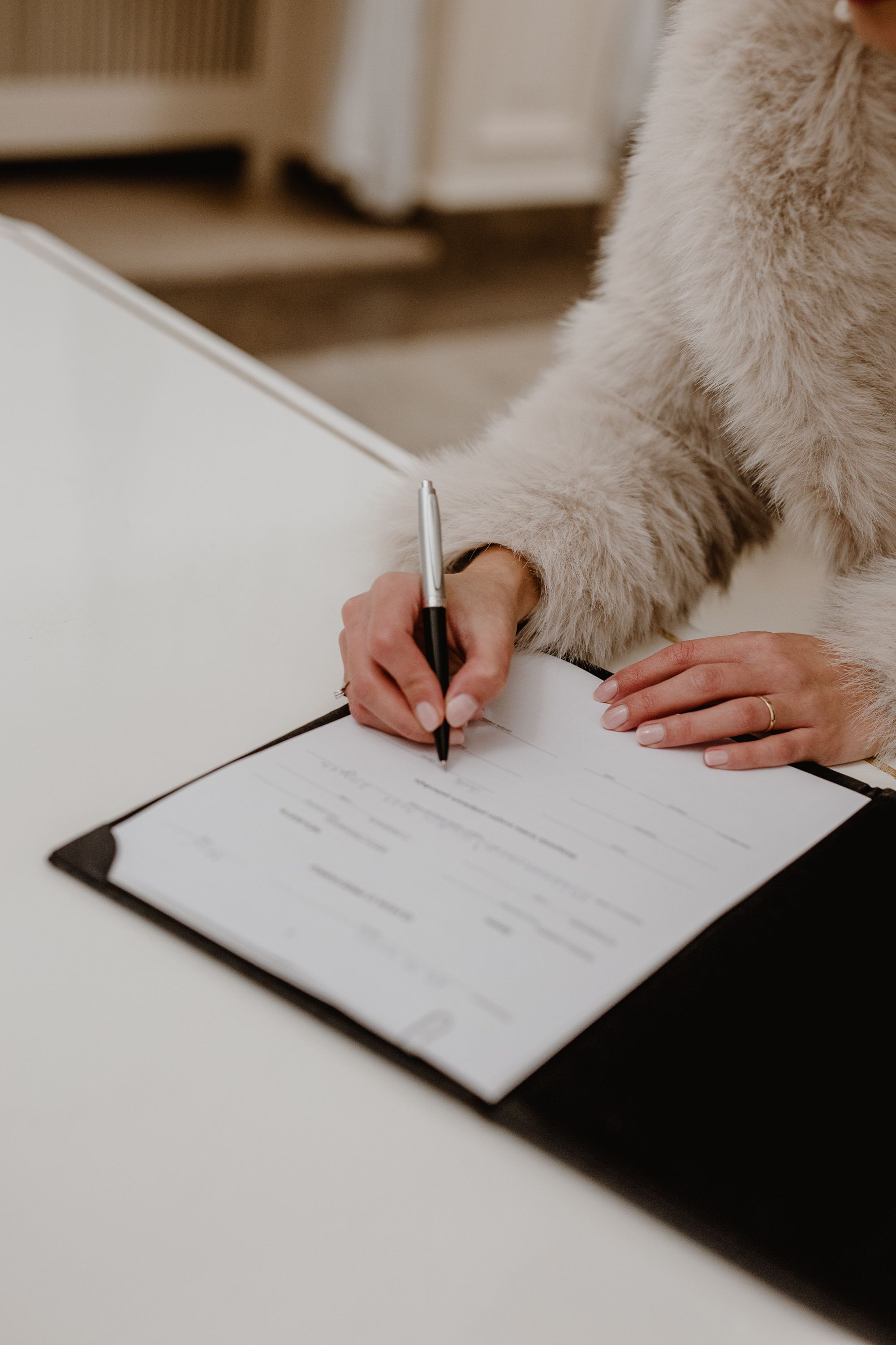 Close-up of the bride’s hand as she signs the wedding register at the Registrar's Office in Upper Town, Zagreb.