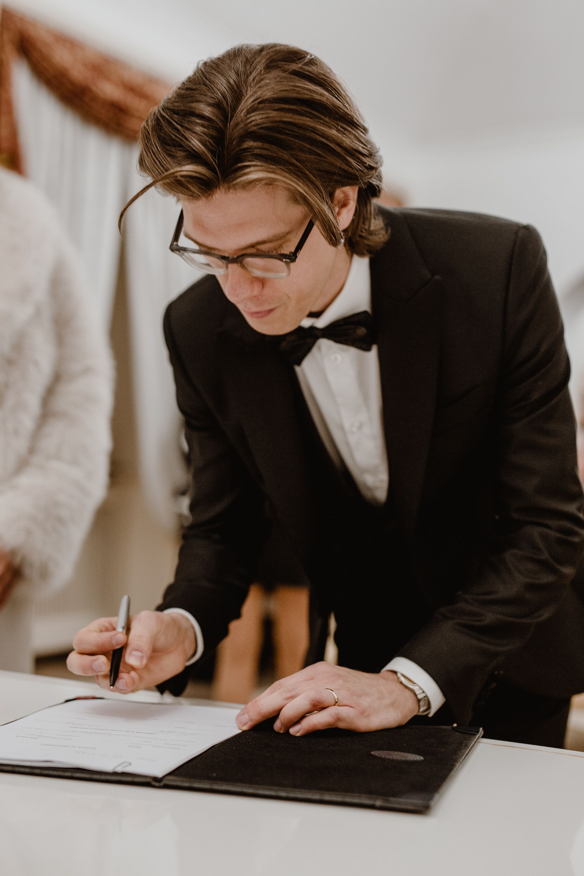 Portrait of the groom as he signs the wedding paperwork at the Registrar's Office in Upper Town, Zagreb.