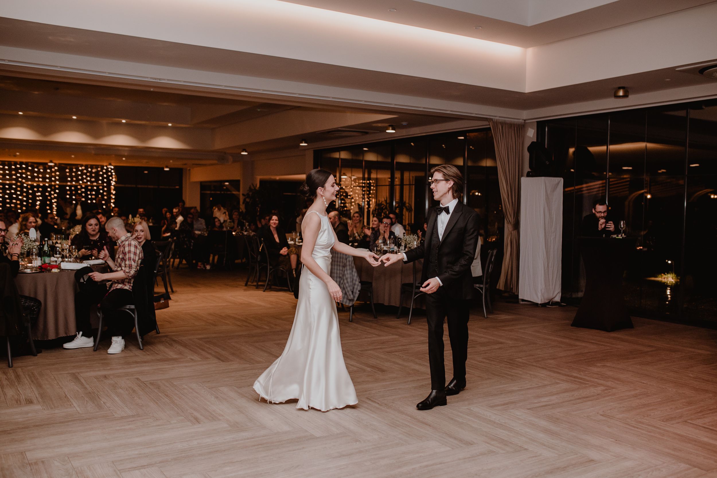 Wide shot of the bride and groom sharing their first dance as newlyweds at their wedding reception in Zagreb Croatia.