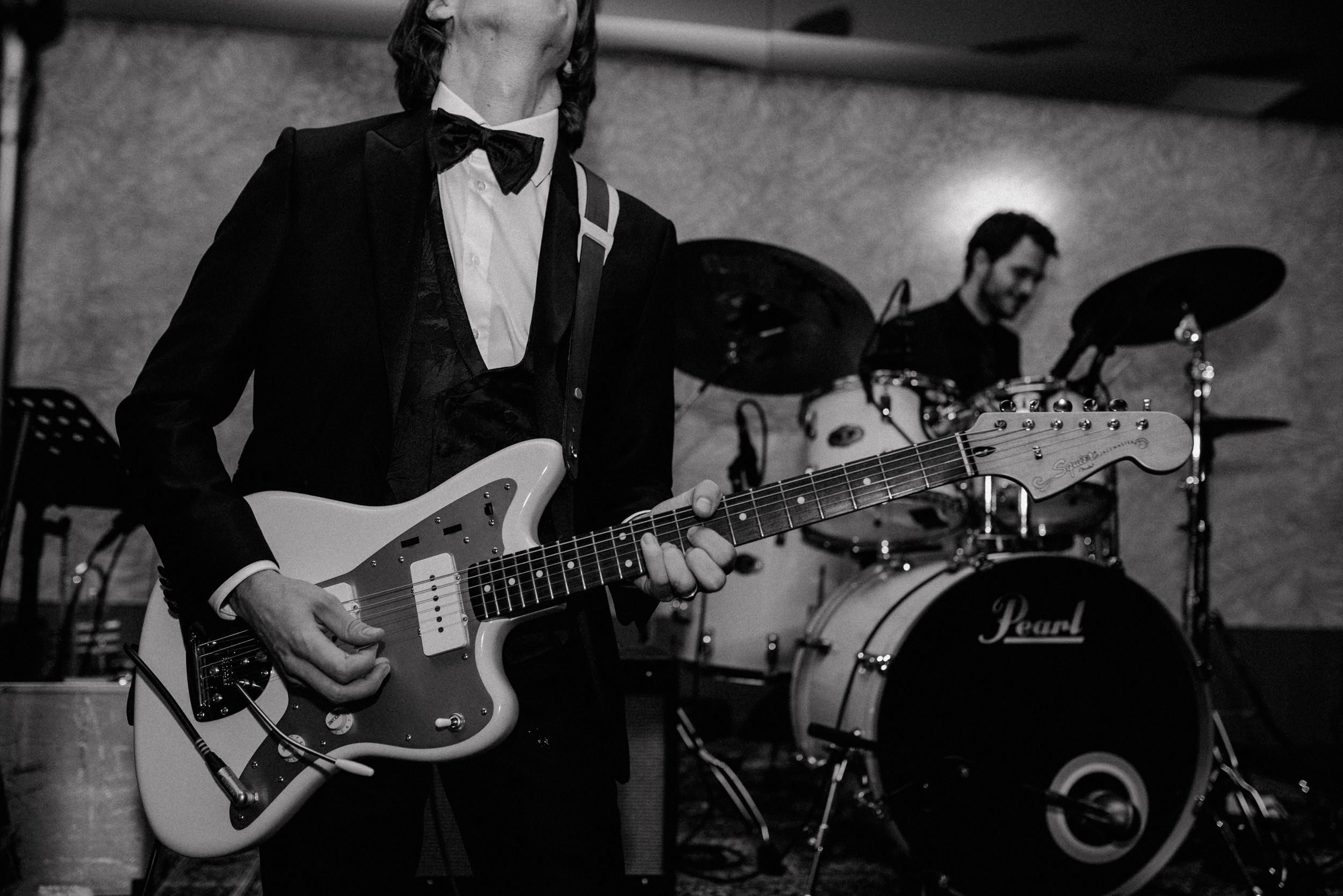 Close up of a grooms guitar while showcasing their music during their wedding party in Zagreb.