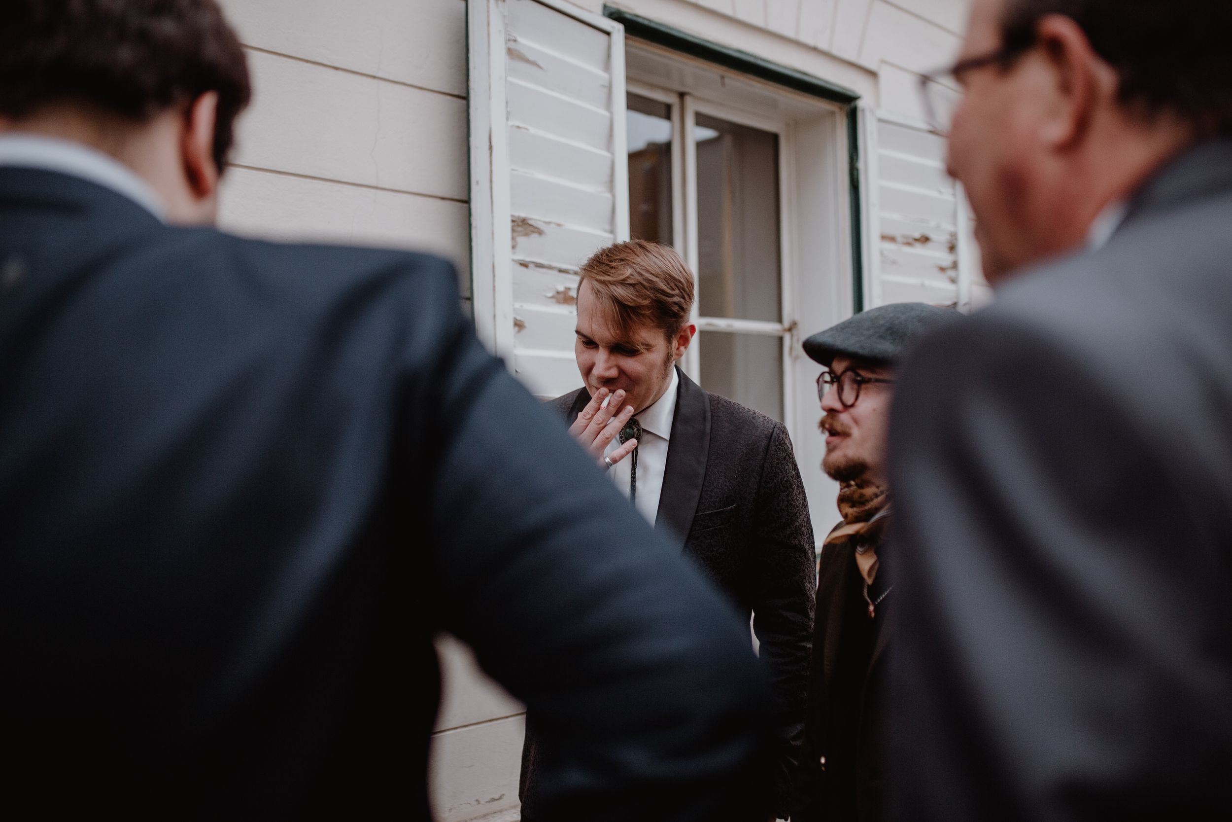 Groomsmen outside a charming Upper Town cafe in Zagreb, capturing a relaxed moment before the wedding ceremony.