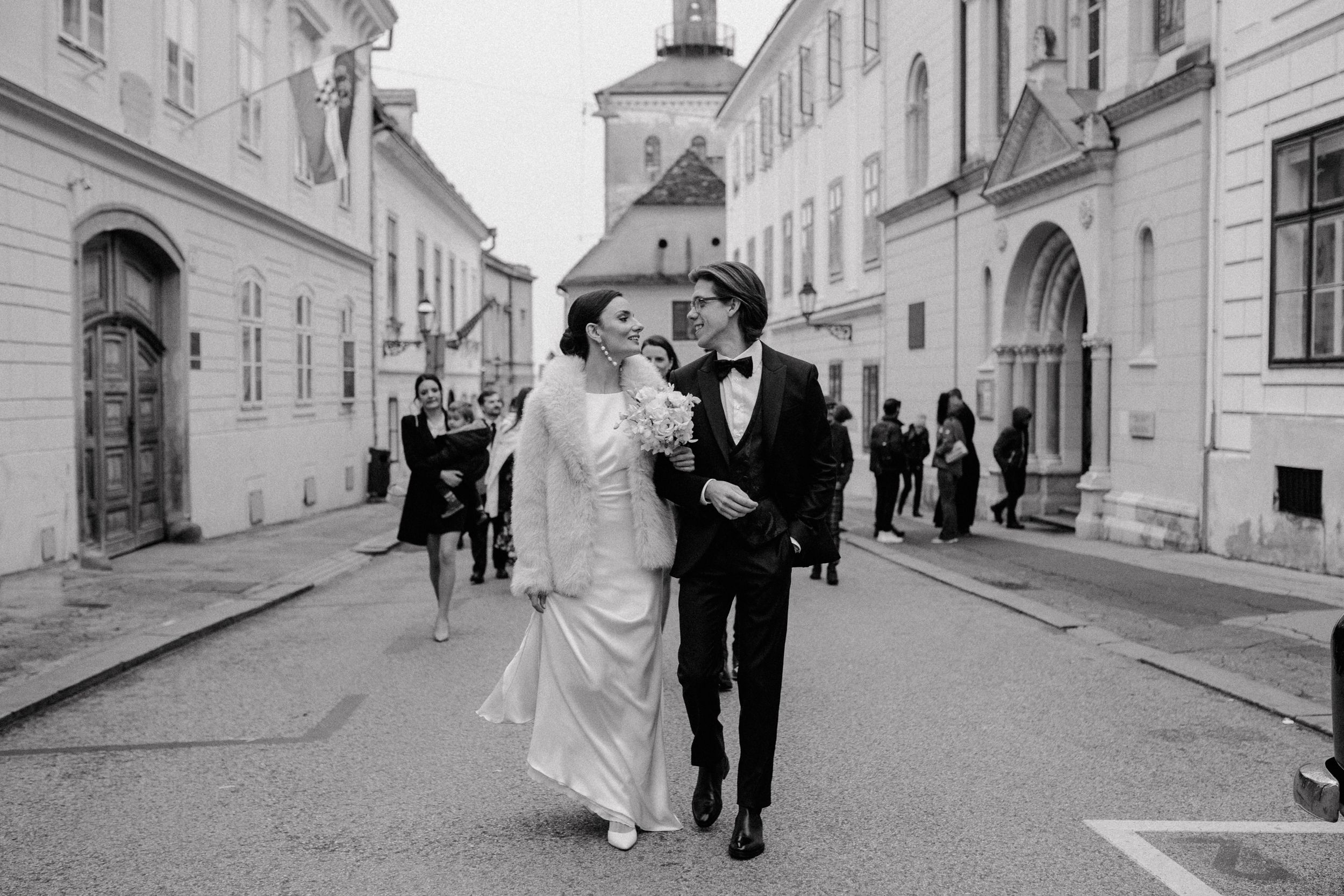 Bride and groom walking hand-in-hand towards the marital office in Upper Town, Zagreb.