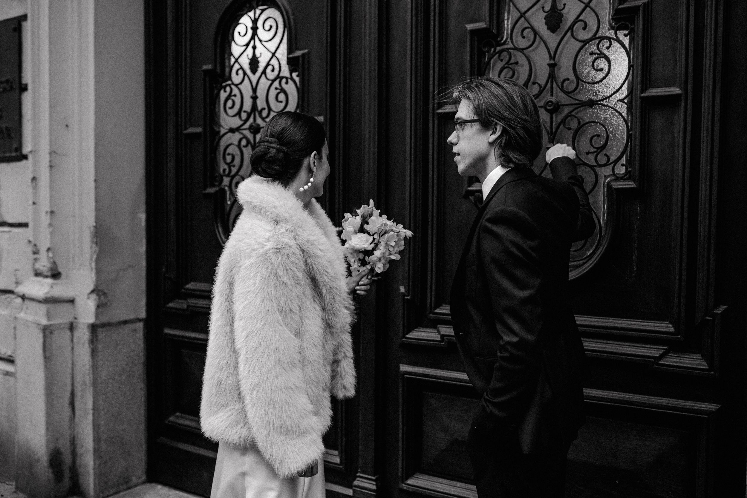 Bride and groom entering the registrar's office on Upper Town in Zagreb in black and white wedding photography..