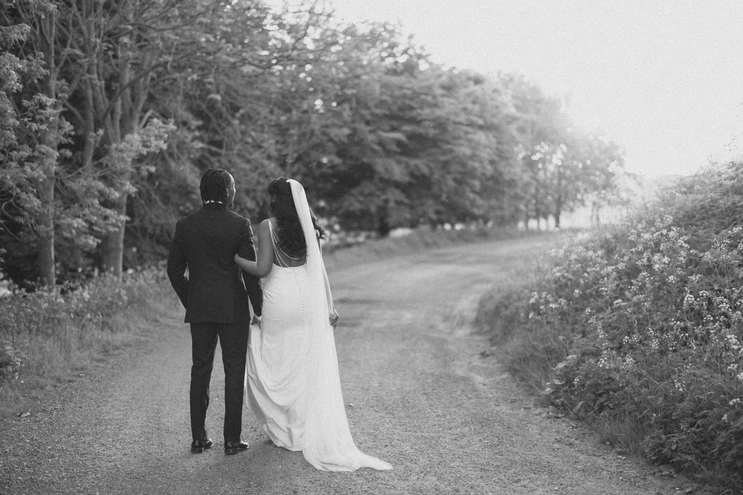 Black and white portrait showcasing elegant bridal makeup and updo hairstyle with pins.