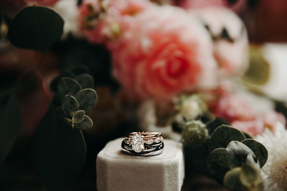 Pink roses and wedding stationery styled with delicate lace details.