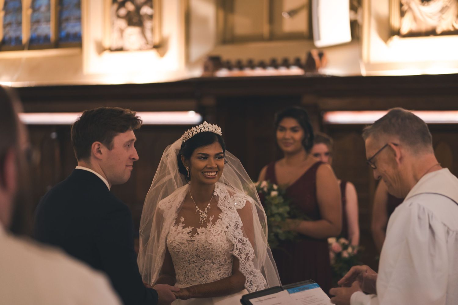 A wedding ceremony taking place inside a traditional church setting.
