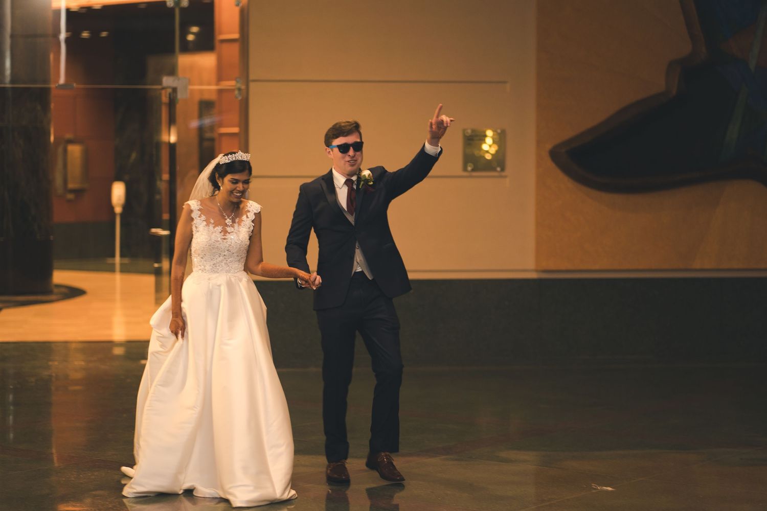 A newlywed couple makes a grand entrance at their wedding reception.