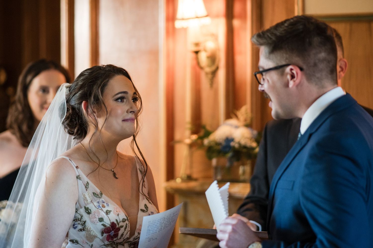 An intimate wedding ceremony moment captured in warm indoor lighting.