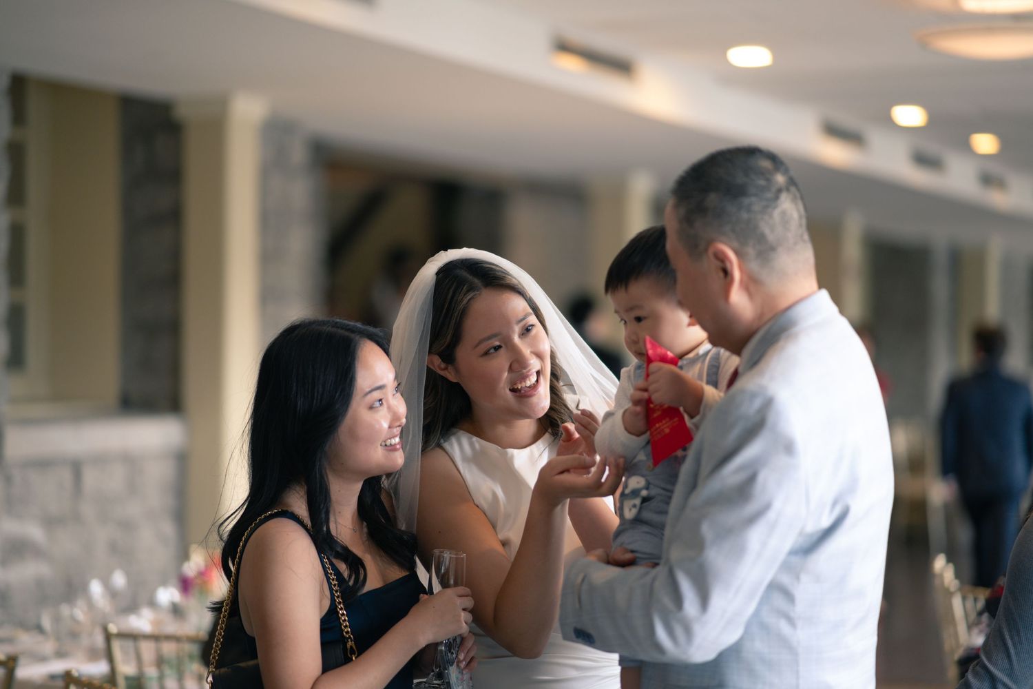 A group of wedding guests sharing a joyful moment during reception celebrations.