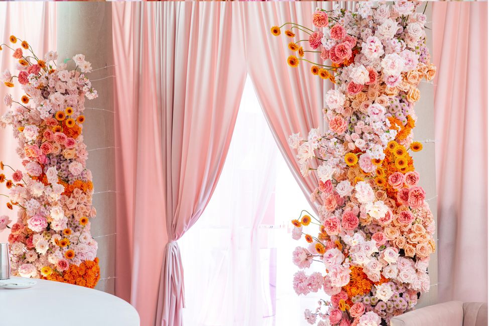 Elegant pink and white curtains decorated with coral and peach floral arrangements.