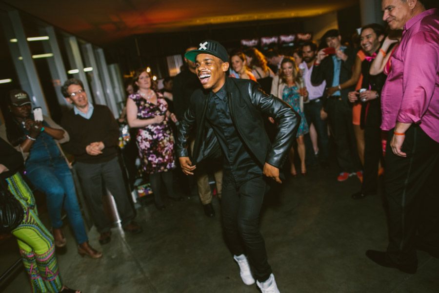 People dancing together on a dark dance floor at a lively celebration or party event.