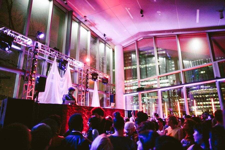 Nightclub interior illuminated with vibrant pink and purple lighting creating a dynamic party atmosphere.