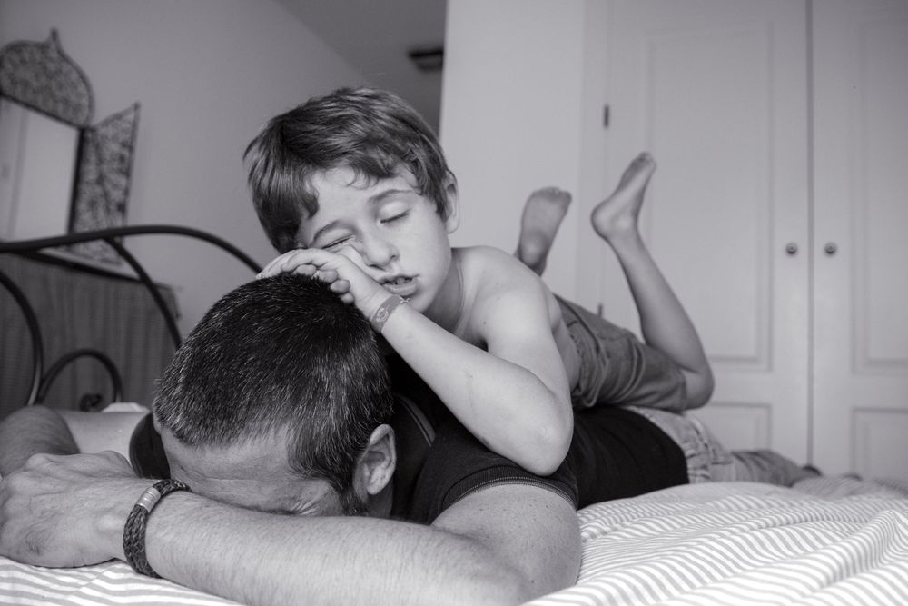 An intimate black and white photograph capturing a tender moment of rest.